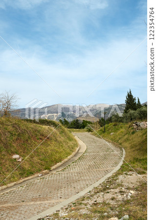 Winding Pathway Through Green Hills and Mountains Winding Pathway Through Green Hills and Mountains 122354764