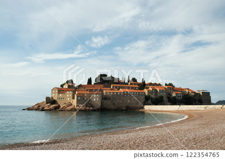 Sveti Stefan island with pebble beach and medieval Mediterranean fishing village at sunrise 122354765