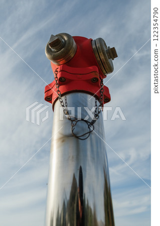 Shiny Red Fire Hydrant Against Blue Sky Shiny Red Fire Hydrant Against Blue Sky 122354790