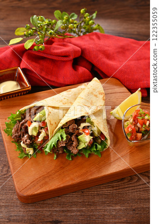 Tortilla, taco, octopus, mexican food. Vegetable rolls with beef and salsa sauce, with avocado. 122355059