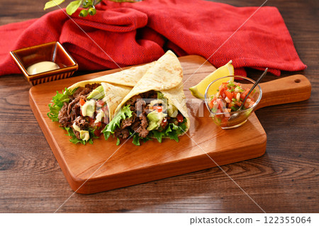 Tortilla, taco, octopus, mexican food. Vegetable rolls with beef and salsa sauce, with avocado. Tortilla, taco, octopus, mexican food. Vegetable rolls with beef and salsa sauce, with avocado. 122355064