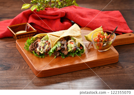 Tortilla, taco, octopus, mexican food. Vegetable rolls with beef and salsa sauce, with avocado. 122355070