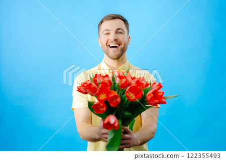Man holding bouquet of red tulips 122355493