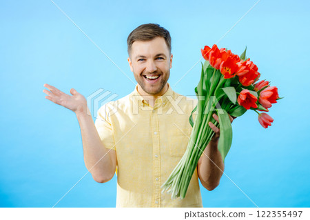 Man holding bunch of red flowers Man holding bunch of red flowers 122355497