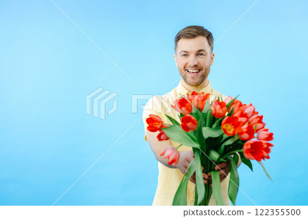 Man holding bouquet of red tulips Man holding bouquet of red tulips 122355500