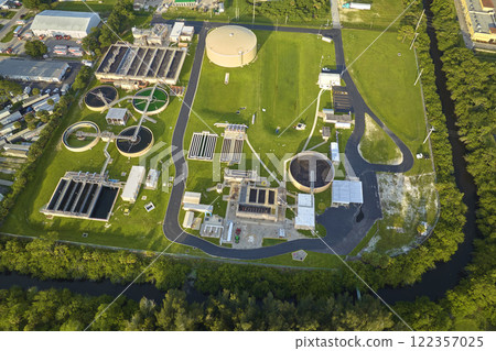 Aerial view of modern water cleaning facility at urban wastewater treatment plant. Purification process of removing undesirable chemicals, suspended solids and gases from contaminated liquid 122357025