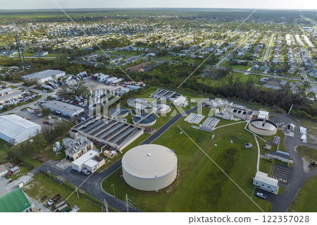 Aerial view of modern water cleaning facility at urban wastewater treatment plant. Purification process of removing undesirable chemicals, suspended solids and gases from contaminated liquid Aerial view of modern water cleaning facility at urban wastewater treatment plant. Purification process of removing undesirable chemicals, suspended solids and gases from contaminated liquid 122357028