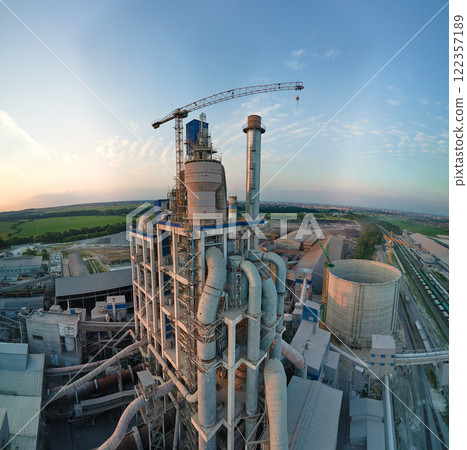 Aerial view of cement factory with high concrete plant structure and tower crane at industrial production site. Manufacture and global industry concept Aerial view of cement factory with high concrete plant structure and tower crane at industrial production site. Manufacture and global industry concept 122357189
