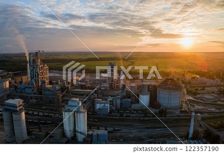 Aerial view of cement factory with high concrete plant structure and tower crane at industrial production area. Manufacture and global industry concept. 122357190