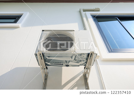 Condenser unit outside home. 122357410