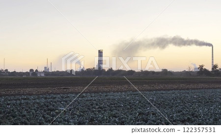 Heavy gray smoke is poured from the chimney pipes of thermal power plant. Carbon dioxide emitting from chimneys from industrial factory into the atmosphere. Concept of environmental pollution problem 122357531