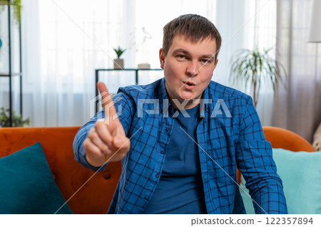 Displeased upset man reacting to unpleasant awful idea dissatisfied with bad quality shake finger No 122357894