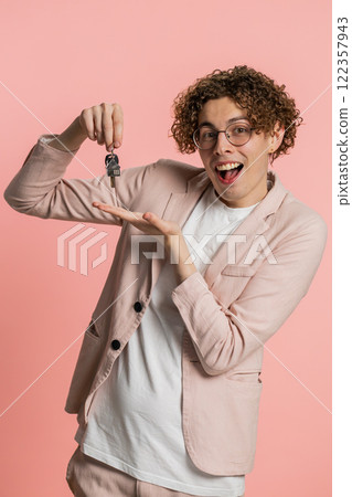 Caucasian man real estate agent showing keys of new home house apartment, buying renting property 122357943