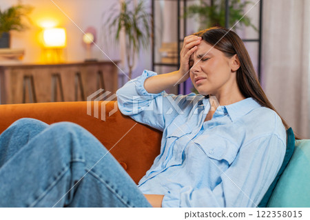 Sick ill Caucasian woman suffering from headache problem, tension and migraine grimacing in pain 122358015