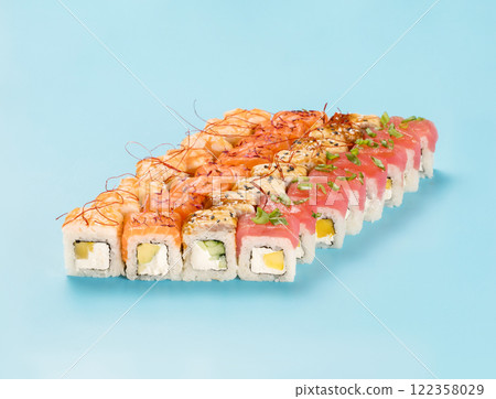 Philadelphia Roll Set with mango, cucumber and avocado, wrapped in perfect seasoned sushi rice and fresh salmon, tuna, shrimp and smoked eel, decorated chili threads. Isolated on light blue background Philadelphia Roll Set with mango, cucumber and avocado, wrapped in perfect seasoned sushi rice and fresh salmon, tuna, shrimp and smoked eel, decorated chili threads. Isolated on light blue background 122358029