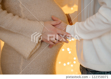 Expectant couple gently cradling baby bump in intimate moment of love and anticipation Expectant couple gently cradling baby bump in intimate moment of love and anticipation 122358071