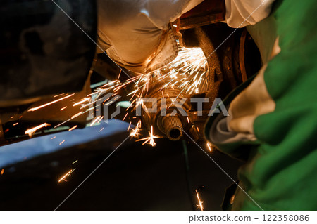Sparks Fly as a Mechanic Performs Precision Metal Work 122358086