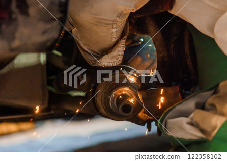 Detail-Oriented Mechanic Performing Precision Welding on Automotive Component Detail-Oriented Mechanic Performing Precision Welding on Automotive Component 122358102