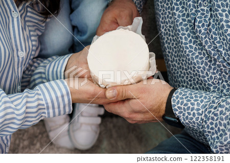 A Couple Sharing a Round Cake During a Cozy Gathering A Couple Sharing a Round Cake During a Cozy Gathering 122358191