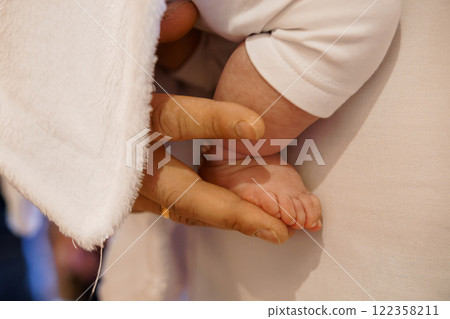 Tender Care: A Close-Up of a Baby's Foot Being Held by an Adult Hand Tender Care: A Close-Up of a Baby's Foot Being Held by an Adult Hand 122358211