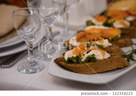 Appetizing Open-Faced Sandwiches with Smoked Salmon and Garnishes on a Table Setting Appetizing Open-Faced Sandwiches with Smoked Salmon and Garnishes on a Table Setting 122358223