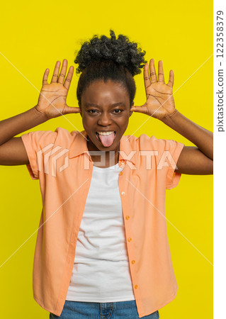 Cheerful funny bully woman showing tongue making silly faces, fooling around joking teasing 122358379