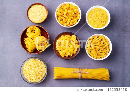 Assorted Uncooked Pasta in Bowls on Wooden Table Assorted Uncooked Pasta in Bowls on Wooden Table 122358458