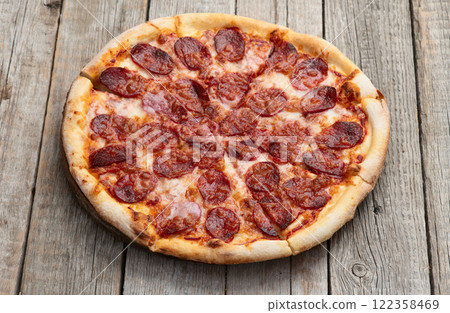 Pizza pepperoni fast food . Top view on rustic background 122358469