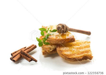 bread fried sweet toasts with honey on wooden board with cinnamon 122358736