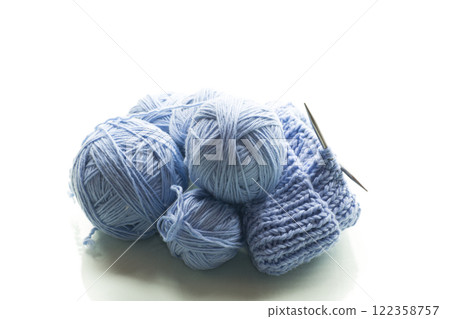 Blue yarn with knitting, isolated on white background Blue yarn with knitting, isolated on white background 122358757