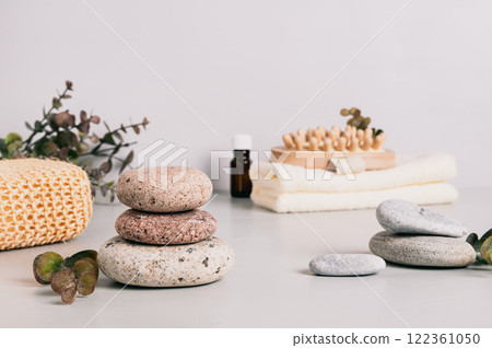 Spa background with items for relaxing procedures and pebbles on the table 122361050
