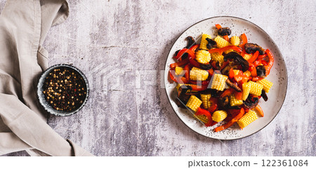 Vegetarian salad with corn cobs, mushrooms and peppers on a plate top view web banner Vegetarian salad with corn cobs, mushrooms and peppers on a plate top view web banner 122361084