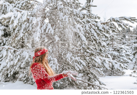 Women Having Fun in Winter Forest during Christmastime 122361503