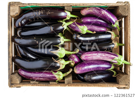 Wooden crate filled with plump eggplants, isolated on white background Wooden crate filled with plump eggplants, isolated on white background 122361527