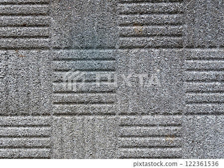 Close-up of patterned concrete texture with grooves and rough surface. 122361536