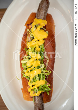 Portion of gourmet american hotdog with sauce Portion of gourmet american hotdog with sauce 122361641