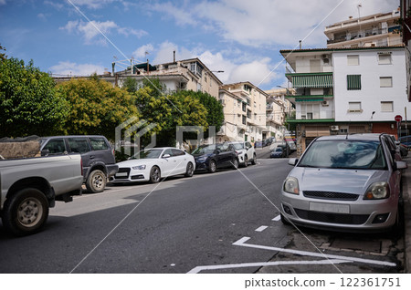 Urban street view with parked cars in a residential neighborhood 122361751