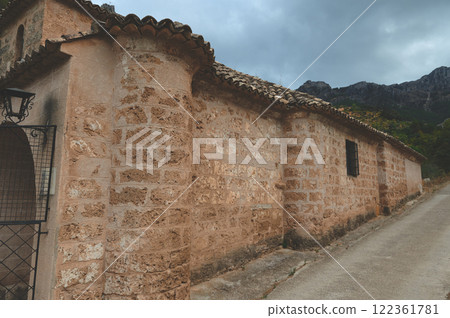 Rustic stone building on countryside road under an overcast sky Rustic stone building on countryside road under an overcast sky 122361781