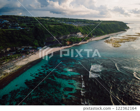 Pandawa beach with coastal landscape, ocean and cloudy sky with morning sunlight in Bali. Pandawa beach with coastal landscape, ocean and cloudy sky with morning sunlight in Bali. 122362164