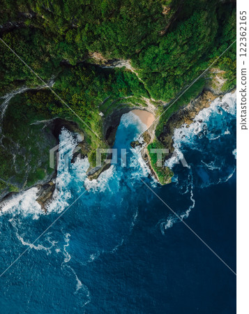Scenic landscape with rocks coastline and ocean with waves in Indonesia. Drone view. Scenic landscape with rocks coastline and ocean with waves in Indonesia. Drone view. 122362165