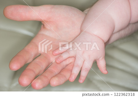 Baby hand holding mother hand Baby hand holding mother hand 122362318