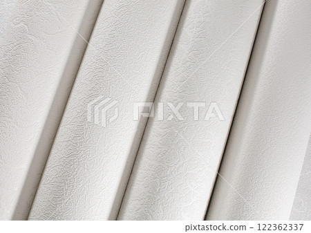 White tubes of paper wallpaper for repairs rolled into rolls. 122362337