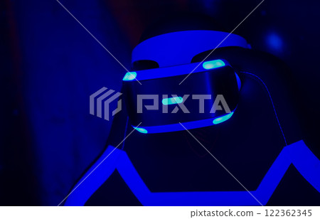 The PS VR headset is glowing on a dark blue background. The PS VR headset is glowing on a dark blue background. 122362345
