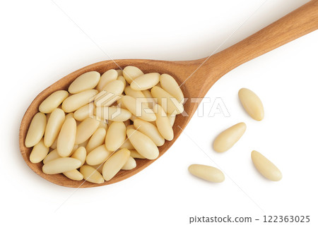 Shelled European pine nuts in wooden spoon isolated on white background with full depth of field. Top view. Flat lay Shelled European pine nuts in wooden spoon isolated on white background with full depth of field. Top view. Flat lay 122363025