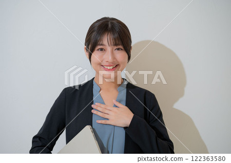 Japanese woman with hands on her chest 122363580