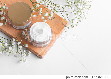 Cosmetic cream jars and gypsophila flowers Cosmetic cream jars and gypsophila flowers 122364116