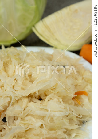 Sauerkraut salad traditional recipe consisting of cabbage, carrots, salt and peppercorns. Sauerkraut salad traditional recipe consisting of cabbage, carrots, salt and peppercorns. 122365196
