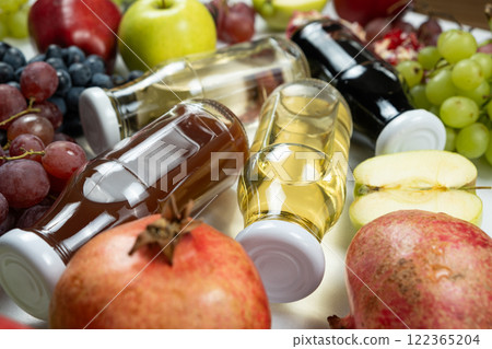 Different types of vinegar balsamic, apple, wine and pomegranate in glass bottles 122365204