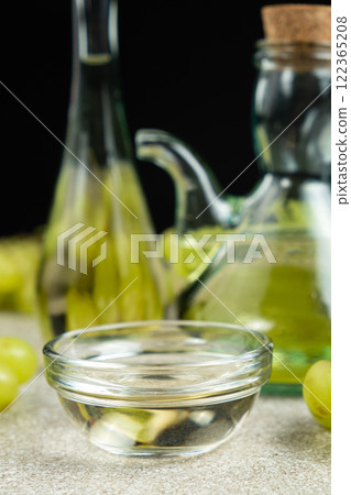 White wine vinegar in a vinegar bowl among grapes 122365208