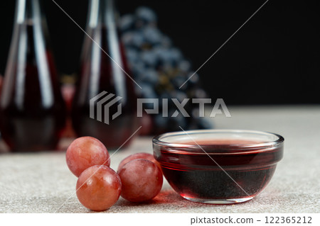 Red wine vinegar in glass vinegar bowls among grapes Red wine vinegar in glass vinegar bowls among grapes 122365212